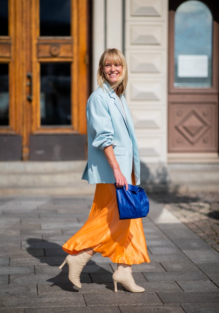 Wear a neutral pair with an orange skirt and blue blazer. Both the boots and your outerwear will help to balance out the tones.