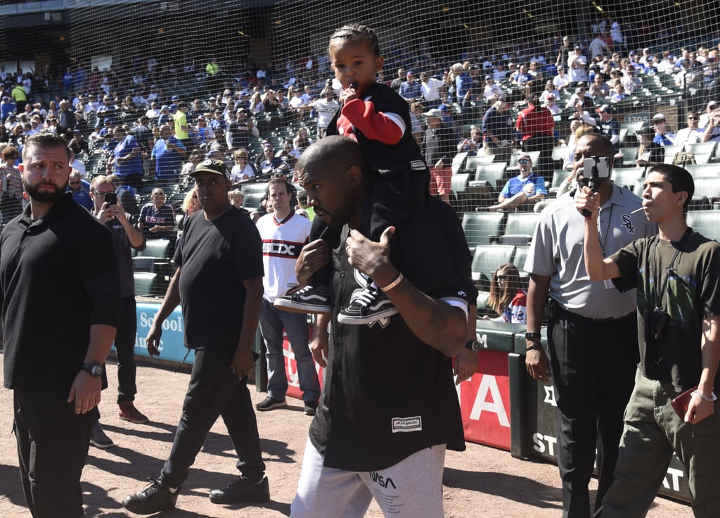 Kanye West and Saint West Throw First Pitch at Baseball Game