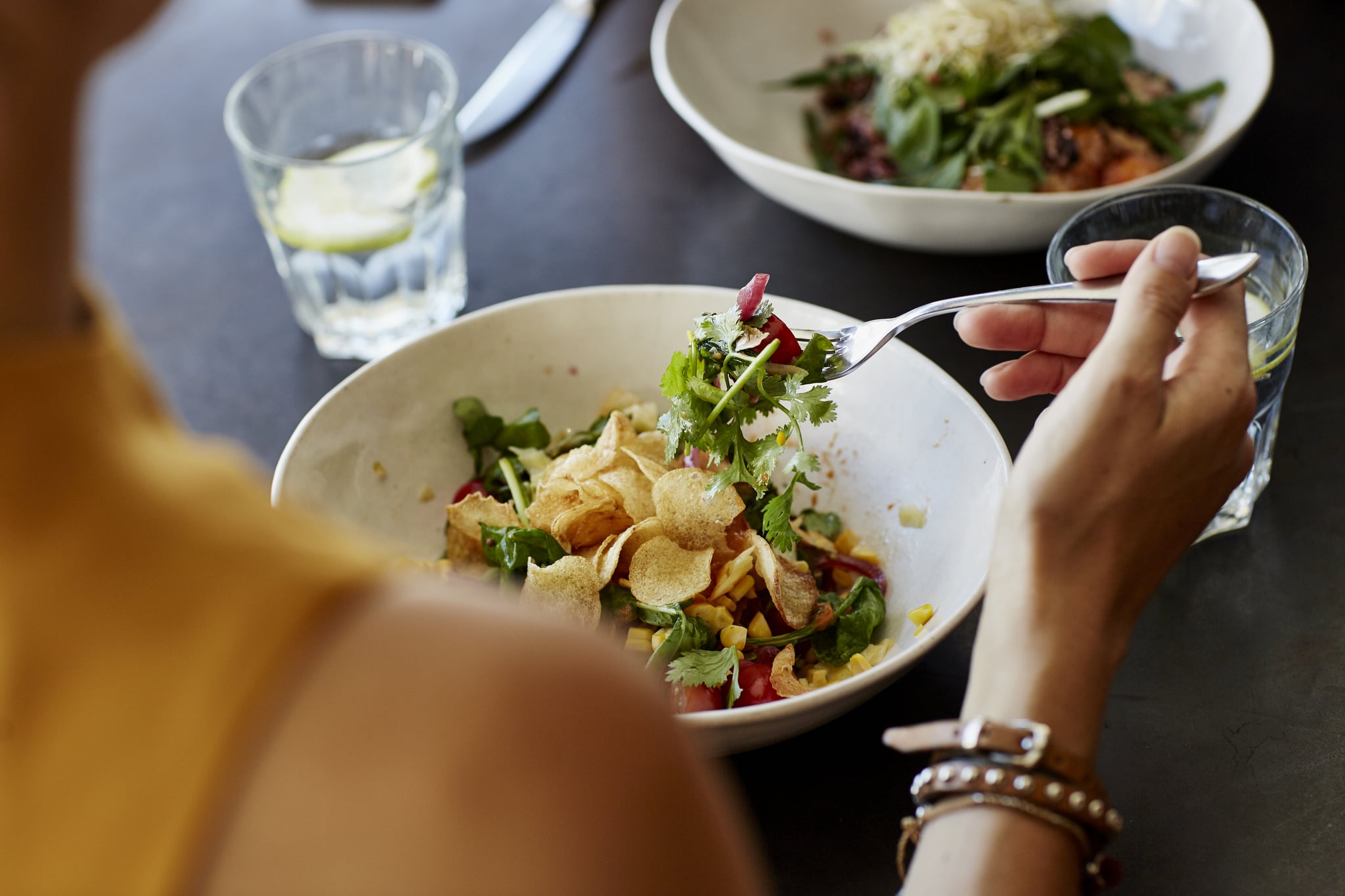 Cropped image of woman eating salad: how much fiber do you need per day?