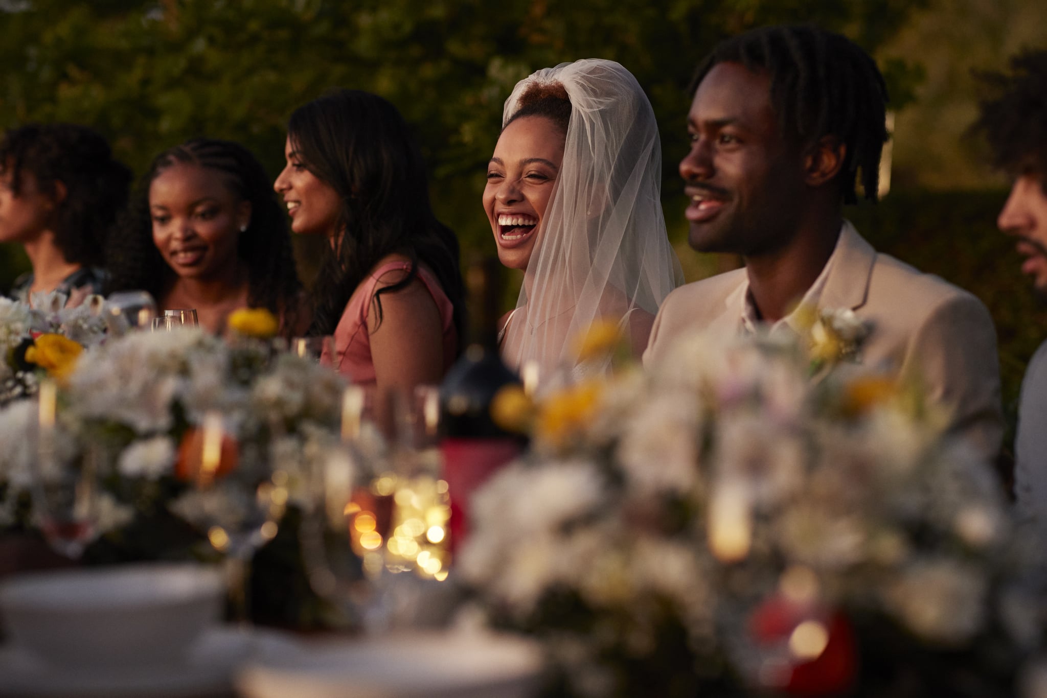 bride and groom seated with guests at their micro wedding