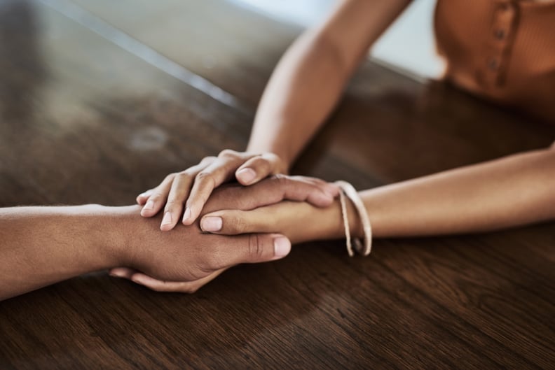 Cropped shot of an unrecognizable man and woman holding hands at a table