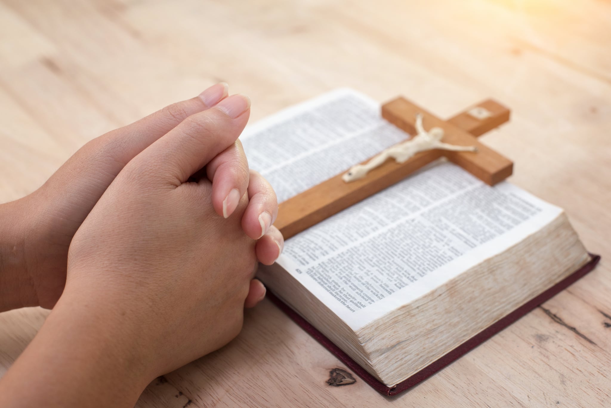 Human hand placed on the Bible, pray to God.