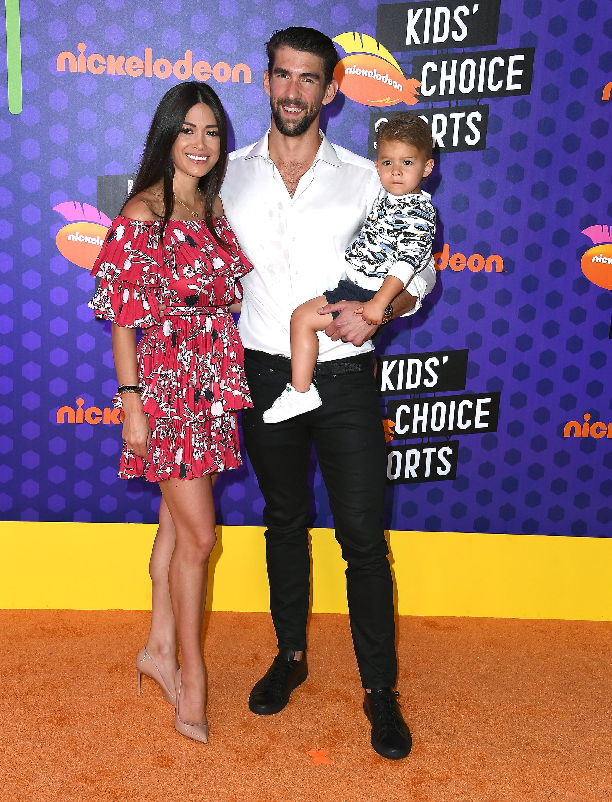 SANTA MONICA, CA - JULY 19:  (L-R) Nicole Johnson, swimmer Michael Phelps, and Boomer Robert Phelps arrives at the Nickelodeon Kids' Choice Sports Awards 2018 at Barker Hangar on July 19, 2018 in Santa Monica, California.  (Photo by Steve Granitz/WireImage)