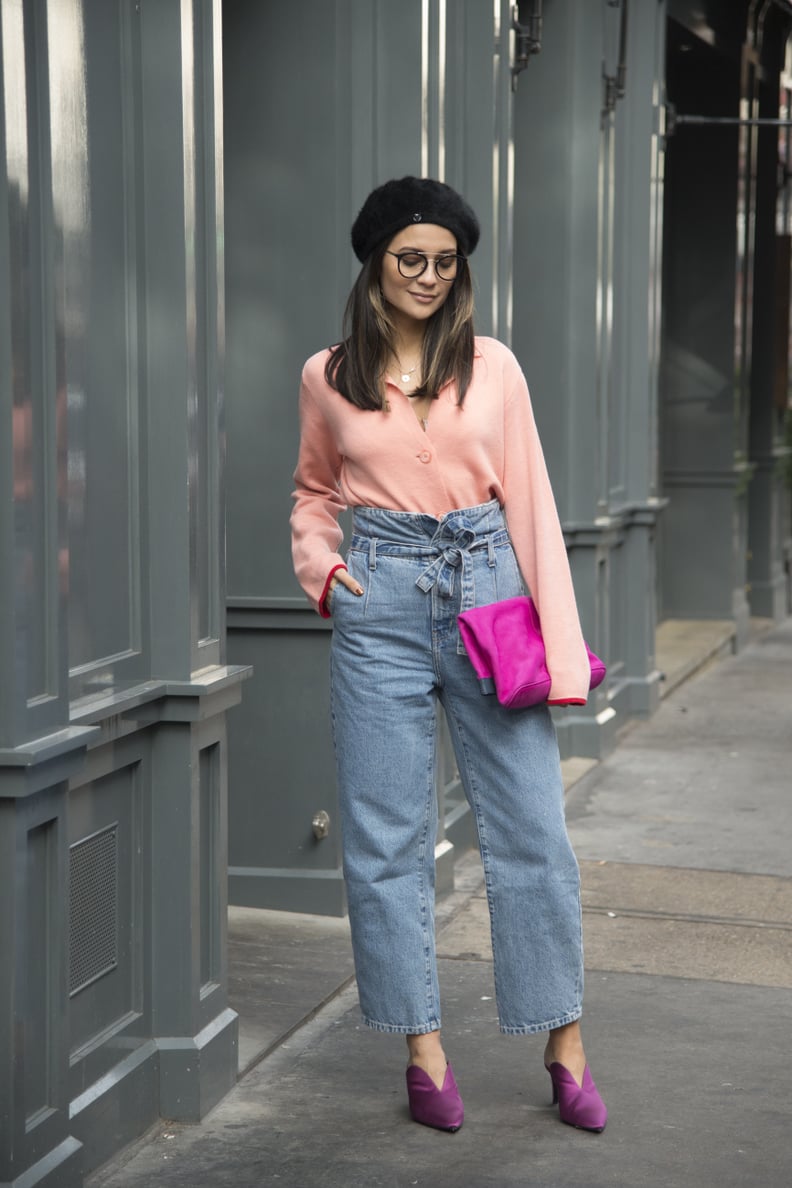 Style with high-waisted jeans, a pastel cardigan, and bright accessories.