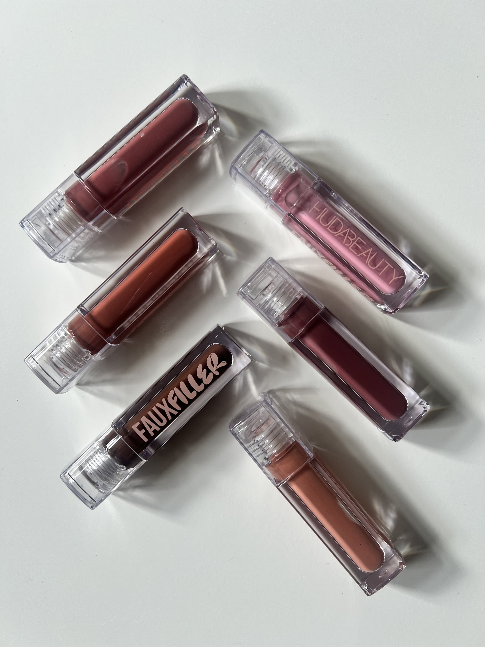 The Huda Beauty Faux Filler Extra Shine Lip Glosses in all six shades.