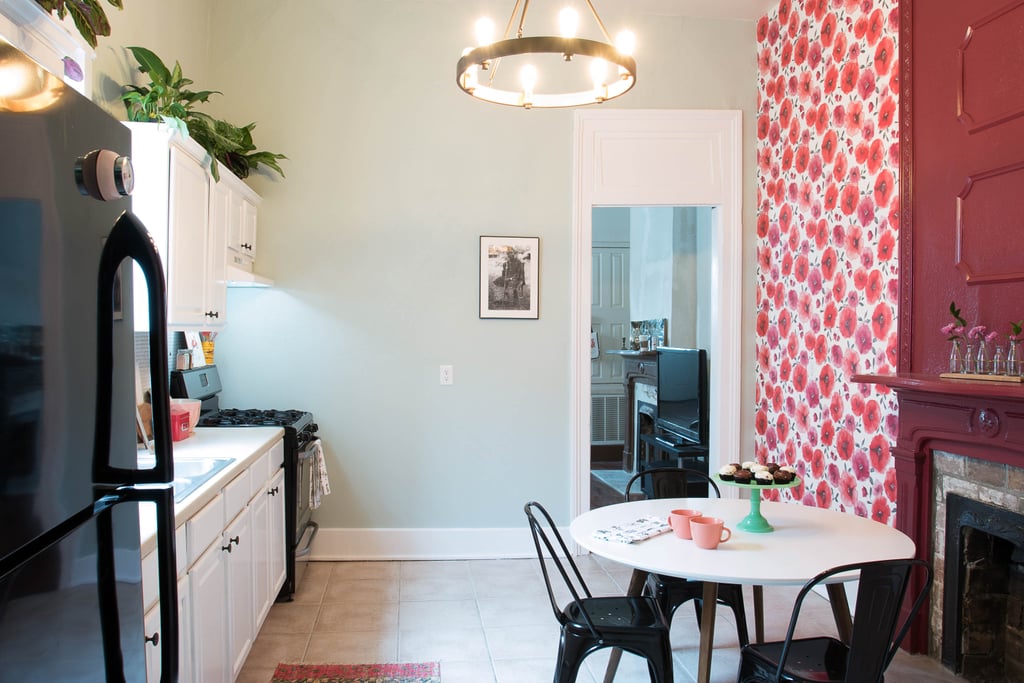 Bye bye, boring white walls! A vibrant red floral wallpaper enlivens the dining area while a beautiful chandelier ($169) make the entire space feel modern. Guests will want to sit down and stay a while at the new table ($401) and chair set ($171) Monica picked out.