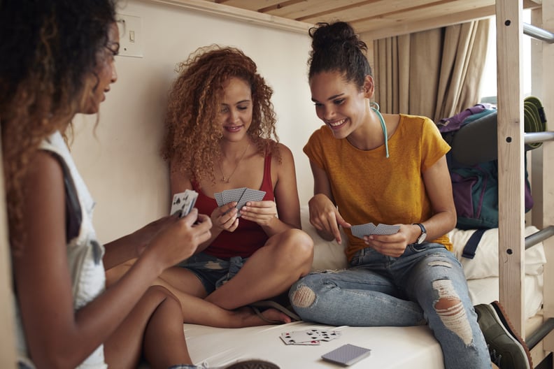 Young women having a good time and hanging out, at youth hostel with bunk beds