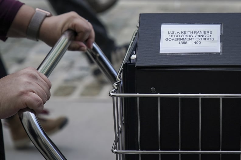 NEW YORK, NY - MAY 7: Staff and members of the prosecution team push carts full of court documents related to the U.S. v. Keith Raniere case as they arrive at the U.S. District Court for the Eastern District of New York a, May 7, 2019 in the Brooklyn boro