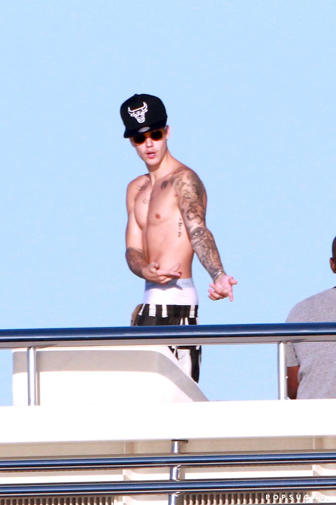 Justin Bieber may be making headlines for his Tuesday scuffle with Orlando Bloom, but that isn't going to stop him from enjoying his vacation in Ibiza. While the Internet was abuzz with his latest drama on Wednesday, the 20-year-old crooner took a ride on a yacht with a group of friends — including several bikini-clad women — off the coast. While Justin appeared to be having fun while riding a water ski and chatting with his pals, he apparently still wasn't over his drama with Orlando Bloom once he was back on dry land. Later in the day, Justin posted a photo of Orlando crying on Instagram in a move that was clearly meant as a dig at the 37-year-old actor. (The picture was quickly deleted.) This isn't the first time that Justin has sent out a dig at Orlando through Instagram, as shortly after their argument, he shared a snap of Miranda Kerr, which he also quickly removed. However, when he first shared his Miranda snap, the news of his fight had yet to surface.
If you're still catching up, Justin and Orlando got into a physical fight at a club in Ibiza on Tuesday night. The two apparently exchanged heated words, and Orlando was seen slapping the singer at one point. Reports differ on what exactly caused the argument, but there are rumors that it was sparked when Justin made a comment about Orlando's ex-wife, Miranda. Justin and Miranda were reportedly spotted getting chummy after the 2012 Victoria's Secret Fashion Show, when she was still married to Orlando. However, Miranda has strongly denied that she ever hooked up with the young pop star. There are also reports that the argument stemmed from reports that Orlando and Justin's ex Selena Gomez were romantically linked, but sources deny that Selena ever got romantic with Orlando.