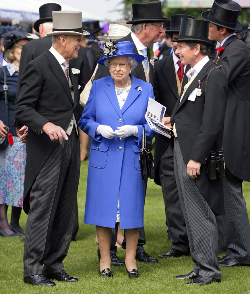 Top hats tower over Her Majesty.