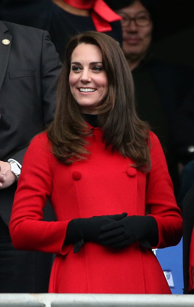 During the RBS Six Nations match between France and Wales, Kate Middleton watched the game while bundled up in a red Carolina Herrera coat. She took a style cue from the Fall '17 runways, choosing black gloves as her main accessory.