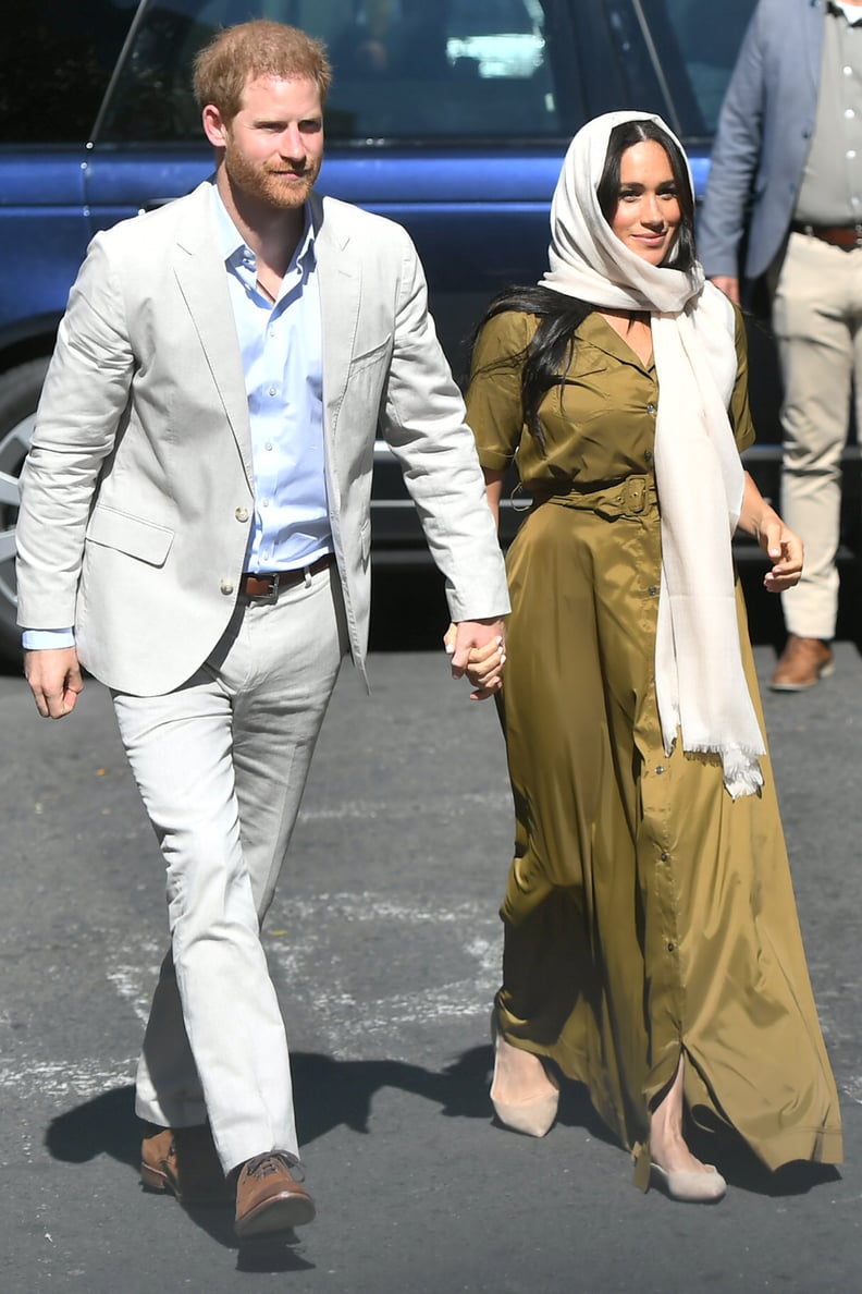 Meghan, Duchess of Sussex Wears An Olive Belted Maxi Dress, Beige Flats, and An Ecru Hair Scarf