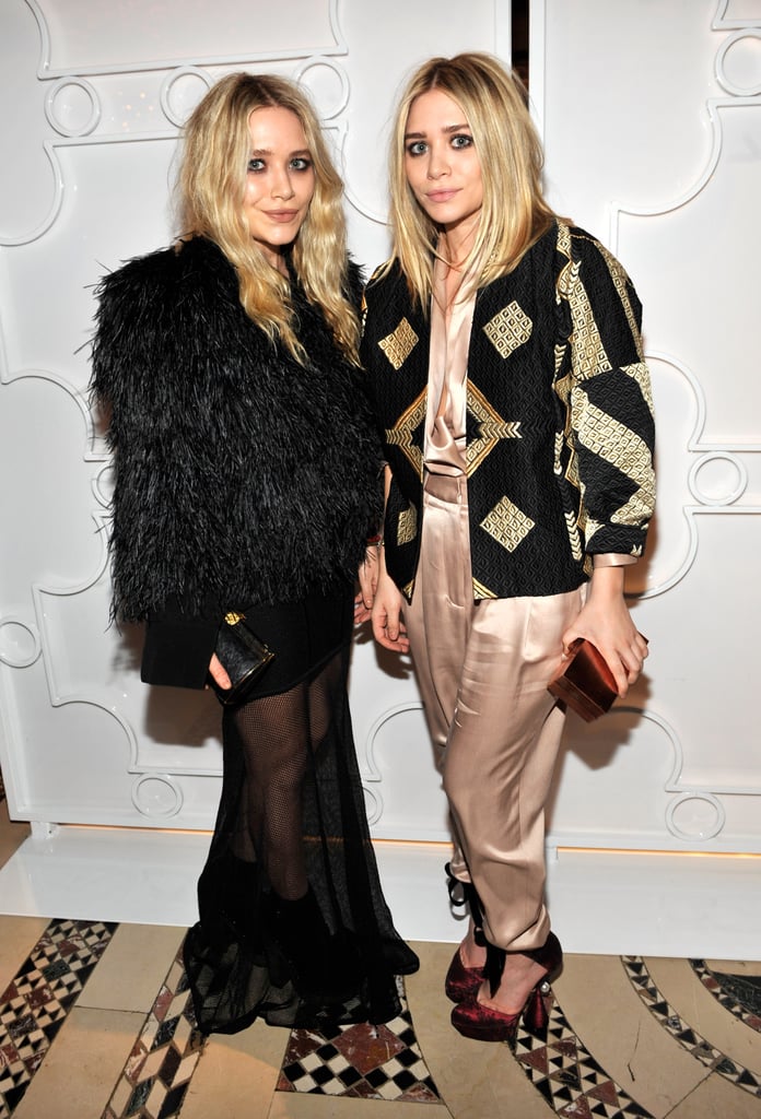 Twinning combo: Once again proving it's all about a statement coat at amfAR's Fall 2010 Fashion Week kickoff party.

Mary-Kate upped the intrigue by layering a full-feathered jacket over her sheer-overlay dress.
Ashley topped her silk champagne separates with a black-and-gold geometric-print jacket.