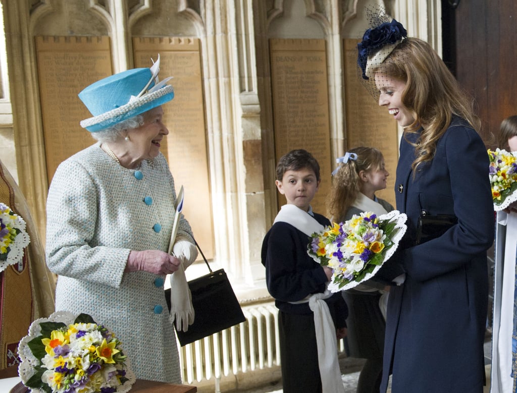 Princess Beatrice once again helped the queen hold her flowers.