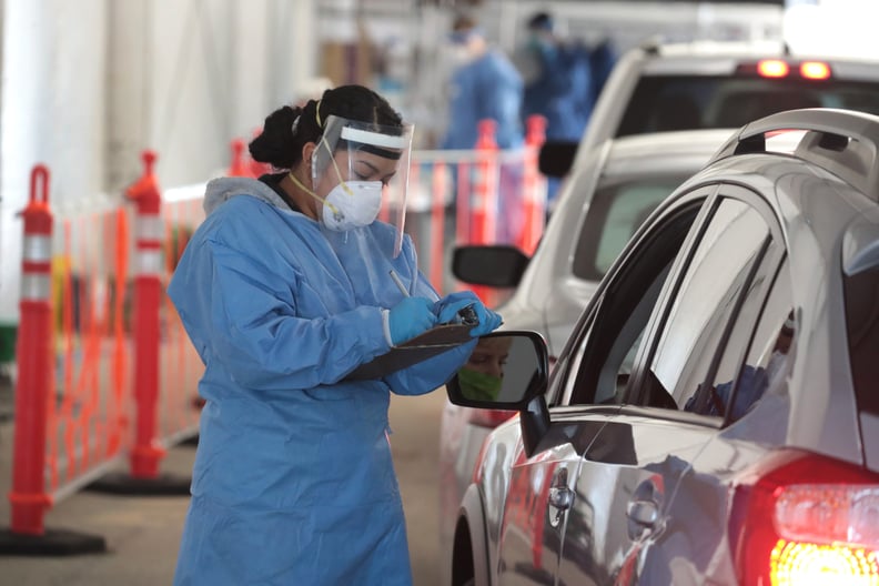 MILWAUKEE, WISCONSIN - NOVEMBER 17: A member of the Wisconsin National Guard helps to test residents for COVID-19 at a drive-up test center at Miller Park on November 17, 2020 in Milwaukee, Wisconsin. Wisconsin recently reported a seven-day average COVID-