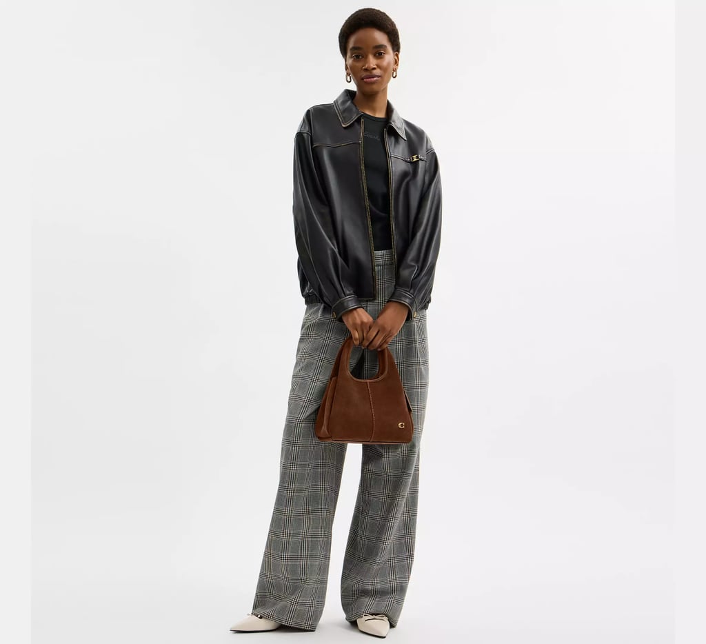 Coach Lana Shoulder Bag 23 ($395)
A hobo bag will always be cool, but given the boho trend's resurgence in fashion this season, this one will have a special place in my closet. I love the small but noticeable signature "C" hardware at the bottom corner, and it's really the perfect size, whether you prefer to wear it crossbody with the detachable strap, or carry it from the top handle. The brass/warm brown suede is described as "velvety" soft, though you can also shop it in five different neutral leather finishes. While I don't often buy myself a bag for the holidays, Coach comes at a contemporary price point and the brand is really having a moment when it comes to personality-infused must haves. I may even tack on this Coach Small Pretzel Bag Charm ($95) as a nod to my love for New York.