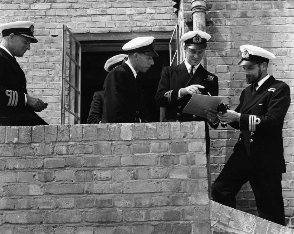 Reviewing Papers (second from right) With Fellow Officers in 1947