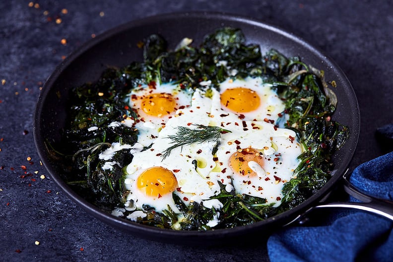 Skillet Baked Eggs With Greens and Feta Yogurt Drizzle