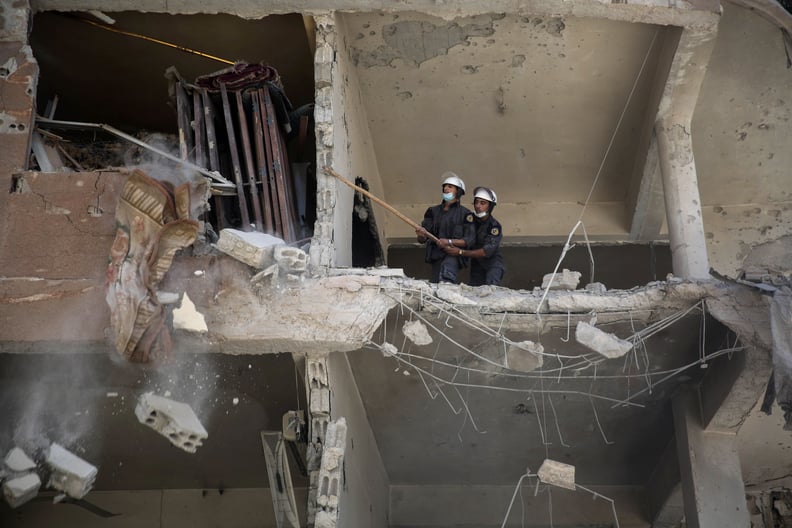 The White Helmets search for victims after an airstrike in Douma.