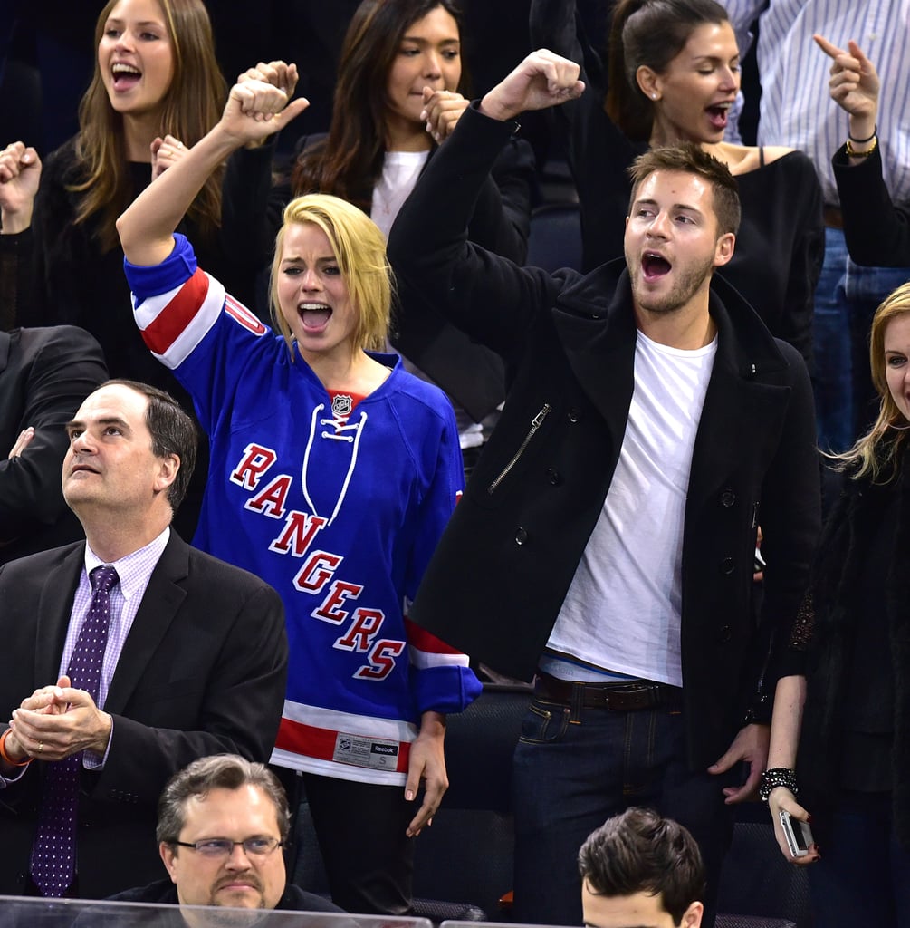Cute pair Margot Robbie and Tom Ackerley were very into the NY Rangers game on Thursday.