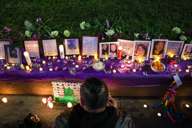 OAKLAND, CALIFORNIA - JANUARY 25: Dr. Cesar Cruz, founder of Homies  Empowerment, pays respects as he decorate a makeshift memorial during a candlelight vigil in honor to the mass shooting victims of the Monterey Park, Half Moon Bay and East Oakland and r