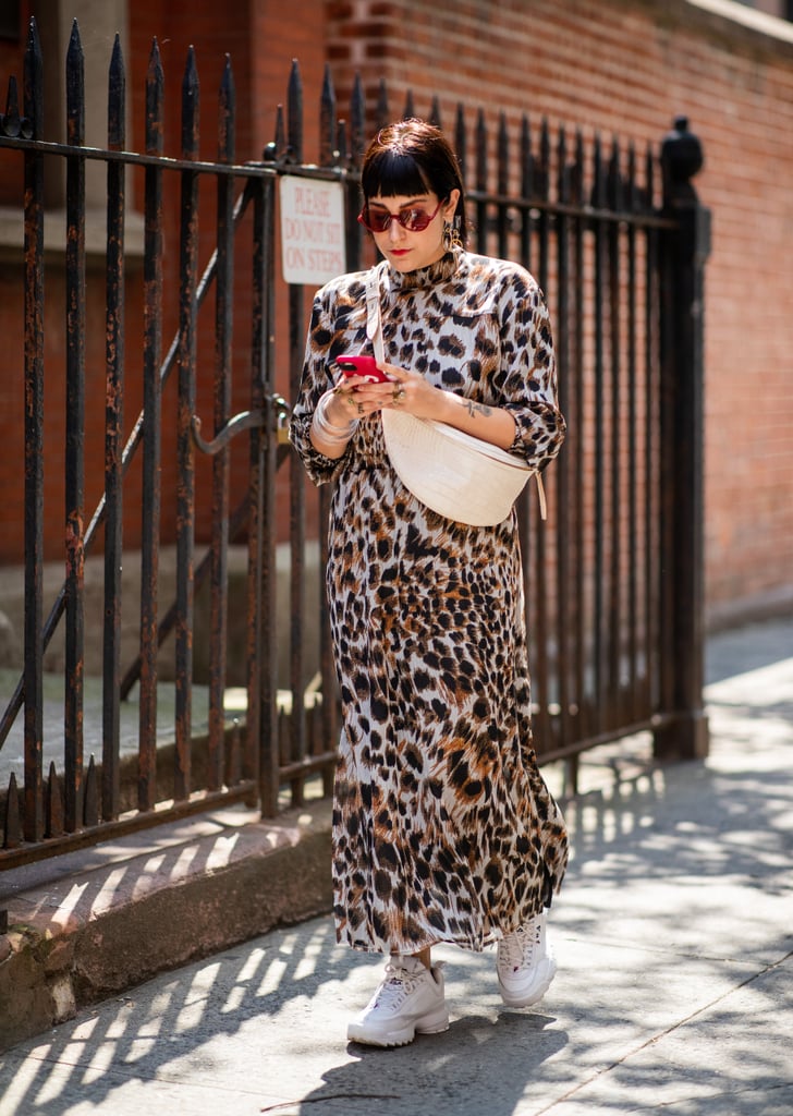 Styling the dress with white sneakers and a fanny pack.