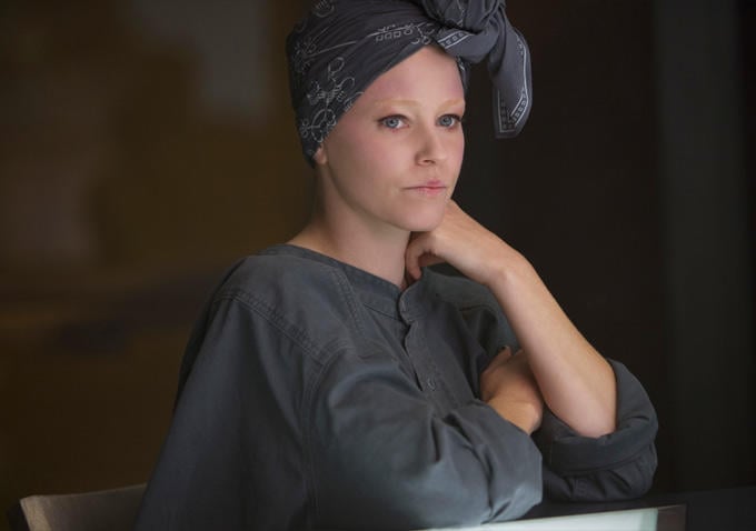 Effie (Elizabeth Banks) has toned down her look for wartime.