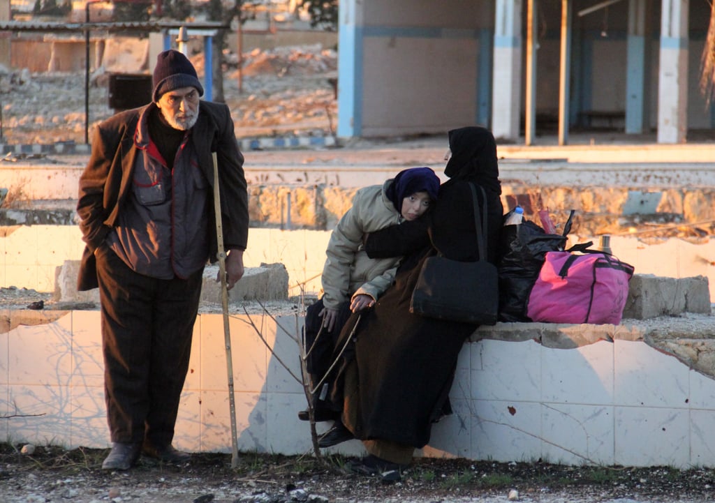 Syrians evacuated from Aleppo arrive to the military-controlled region called Khan al-Aassal on Dec. 15. From there, humanitarian groups will transport them to temporary camps on the outskirts of the province of Idlib.
