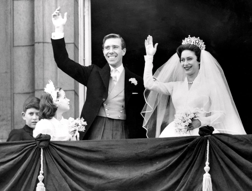 The newlyweds wave to the thousands of people gathered below.