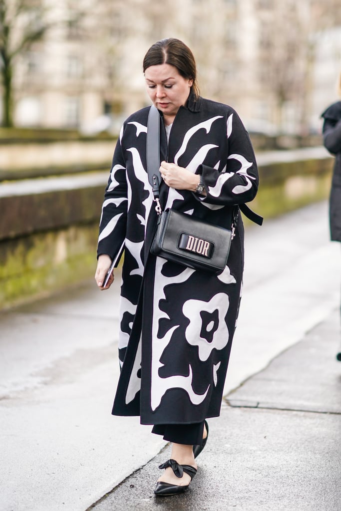 Work a bow-adorned style with a floor-length printed coat.