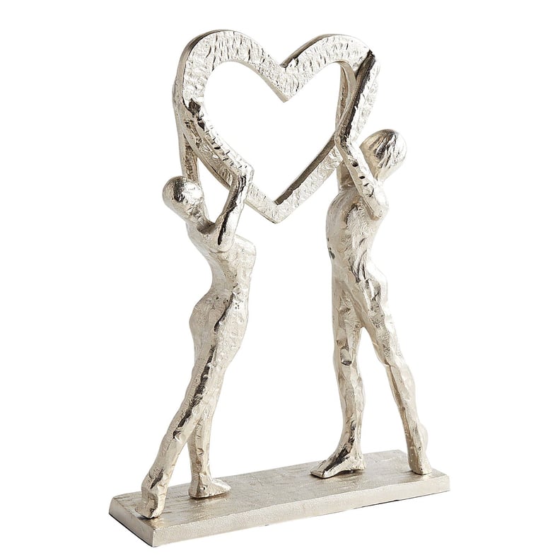 Couple Holding Heart Sculpture