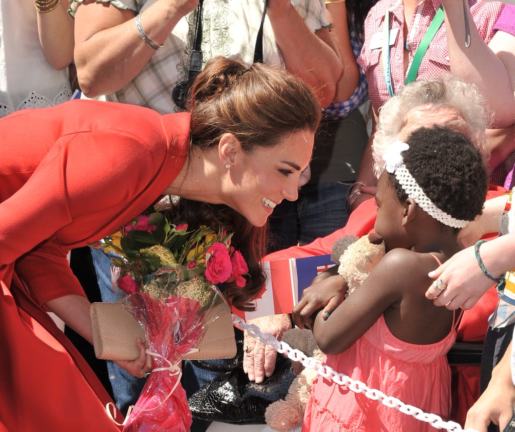 Everybody say awww! The princess looked downright delighted to accept a bouquet of flowers from this cute little girl at the Calgary Zoo in July 2011.