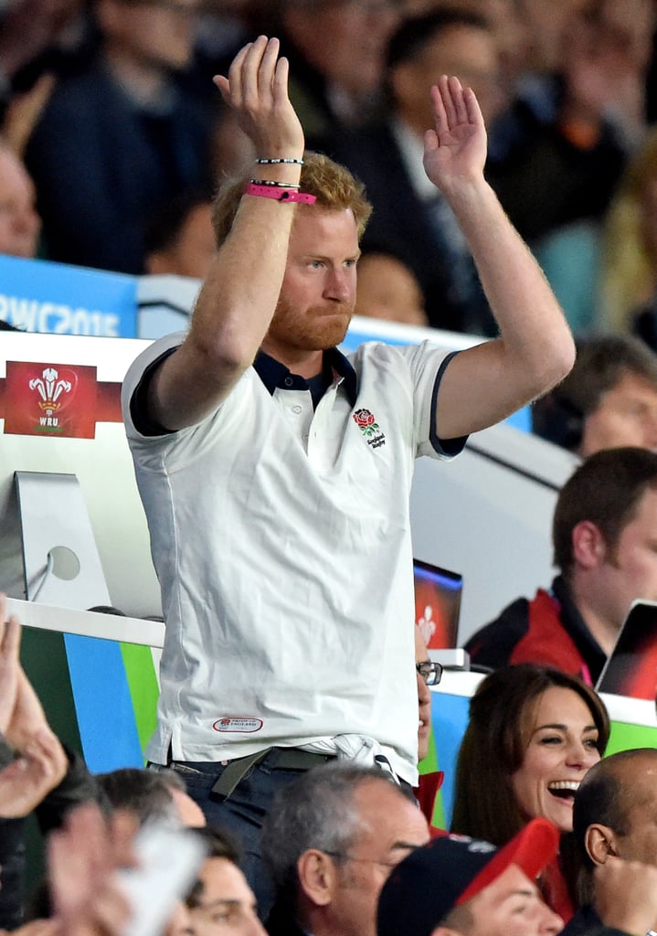 Prince Harry raised his arms over his read during the Rugby World Cup in September 2015.