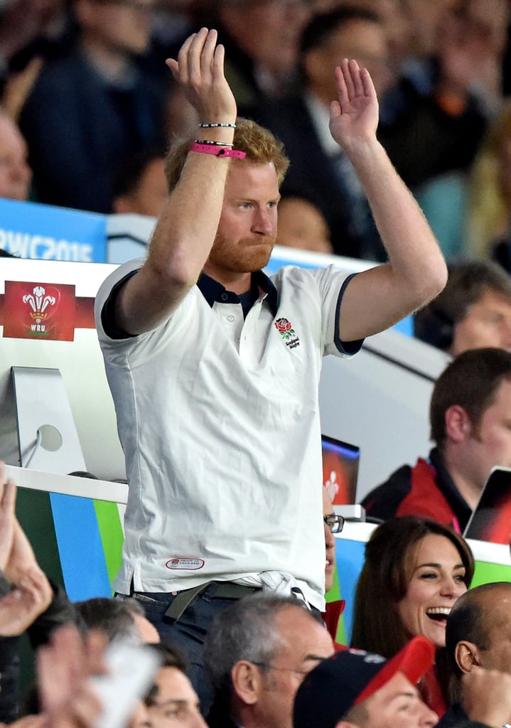 Prince Harry raised his arms over his read during the Rugby World Cup in September 2015.
