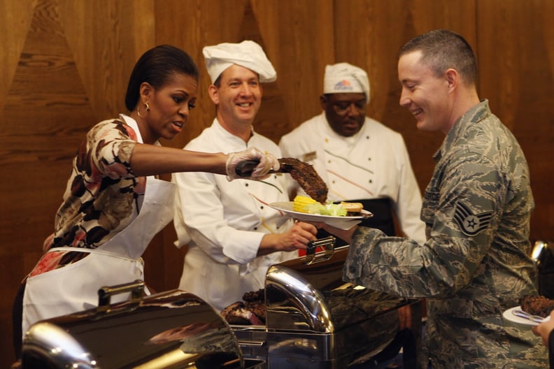 Serving soldiers dinner during a visit to a German air force base in 2010.