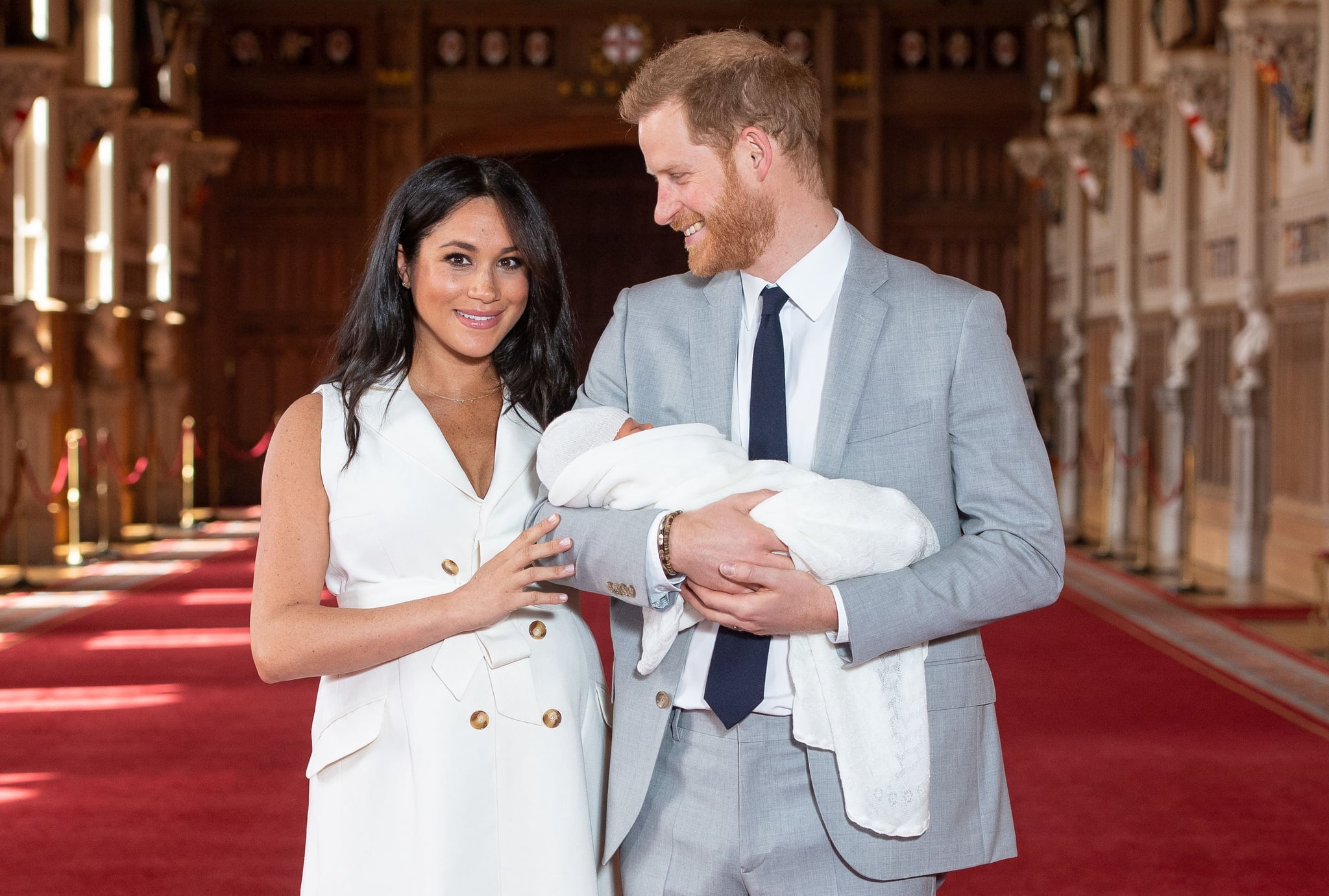 Britain's Prince Harry, Duke of Sussex (R), and his wife Meghan, Duchess of Sussex, pose for a photo with their newborn baby son, Archie Harrison Mountbatten-Windsor, in St George's Hall at Windsor Castle in Windsor, west of London on May 8, 2019. (Photo by Dominic Lipinski / POOL / AFP)        (Photo credit should read DOMINIC LIPINSKI/AFP/Getty Images)