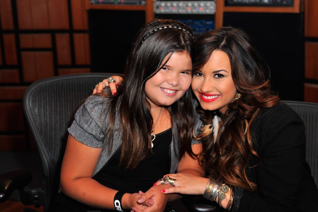 Aug. 20 marked Demi Lovato's 26th birthday, and her 16-year-old sister, Madison De La Garza, made sure to honor Demi on her special day. Along with a childhood photo of the pair, Madison shared an emotional post, thanking God, Demi's team, and her fans for all of their support following Demi's reported drug overdose last month. 
"Today could have been one of the worst days of my life . . . without all of these people I wouldn't have my big sister anymore," she wrote. Madison also shared some of her favorite memories with Demi, adding, "I wish that everyone could see the silly little things that she does, like how her nostrils move when she says certain words and when she brushes my hair behind my ear when I'm trying to sleep." 
Demi was hospitalized on July 24 after she was found unconscious at her LA home due to an apparent drug overdose. Demi is currently receiving treatment at a rehab facility and shared a message for her fans on Instagram earlier this month. "I will keep fighting," she wrote. Take a look at some of Demi and Madison's sweetest sisterly moments ahead.
