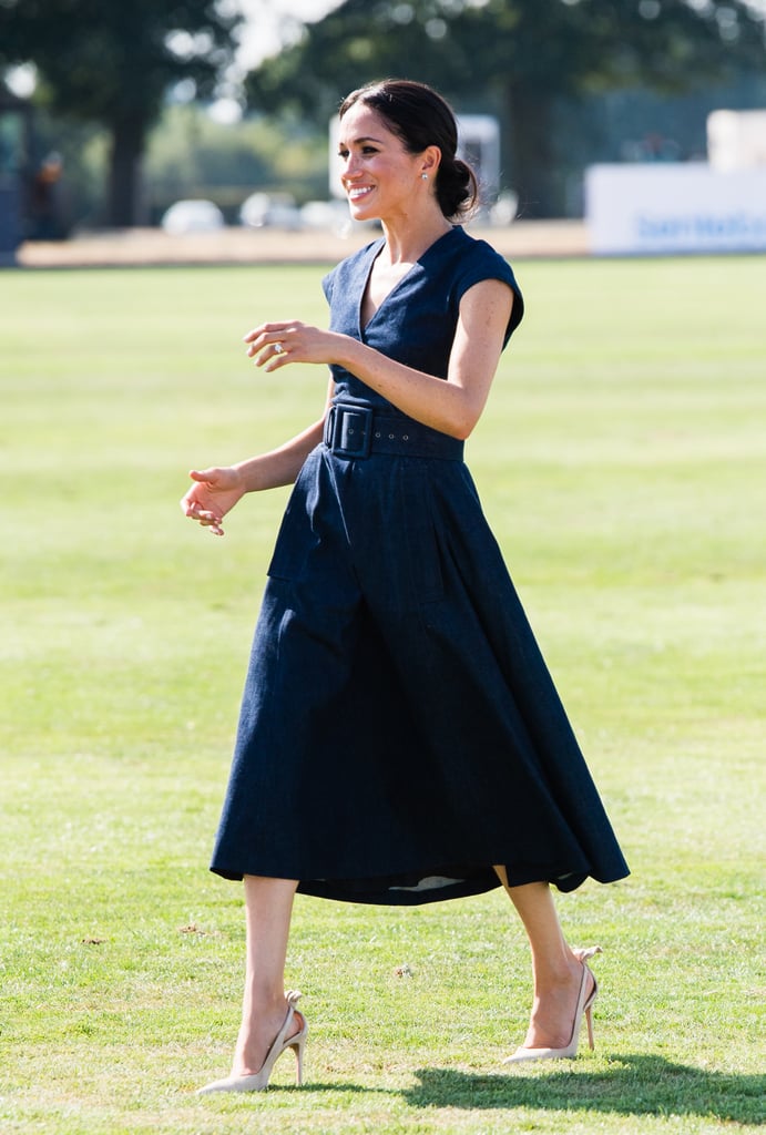 Meghan rocked her Aquazzura bow slingbacks with a denim Carolina Herrera dress at the polo in July 2018.