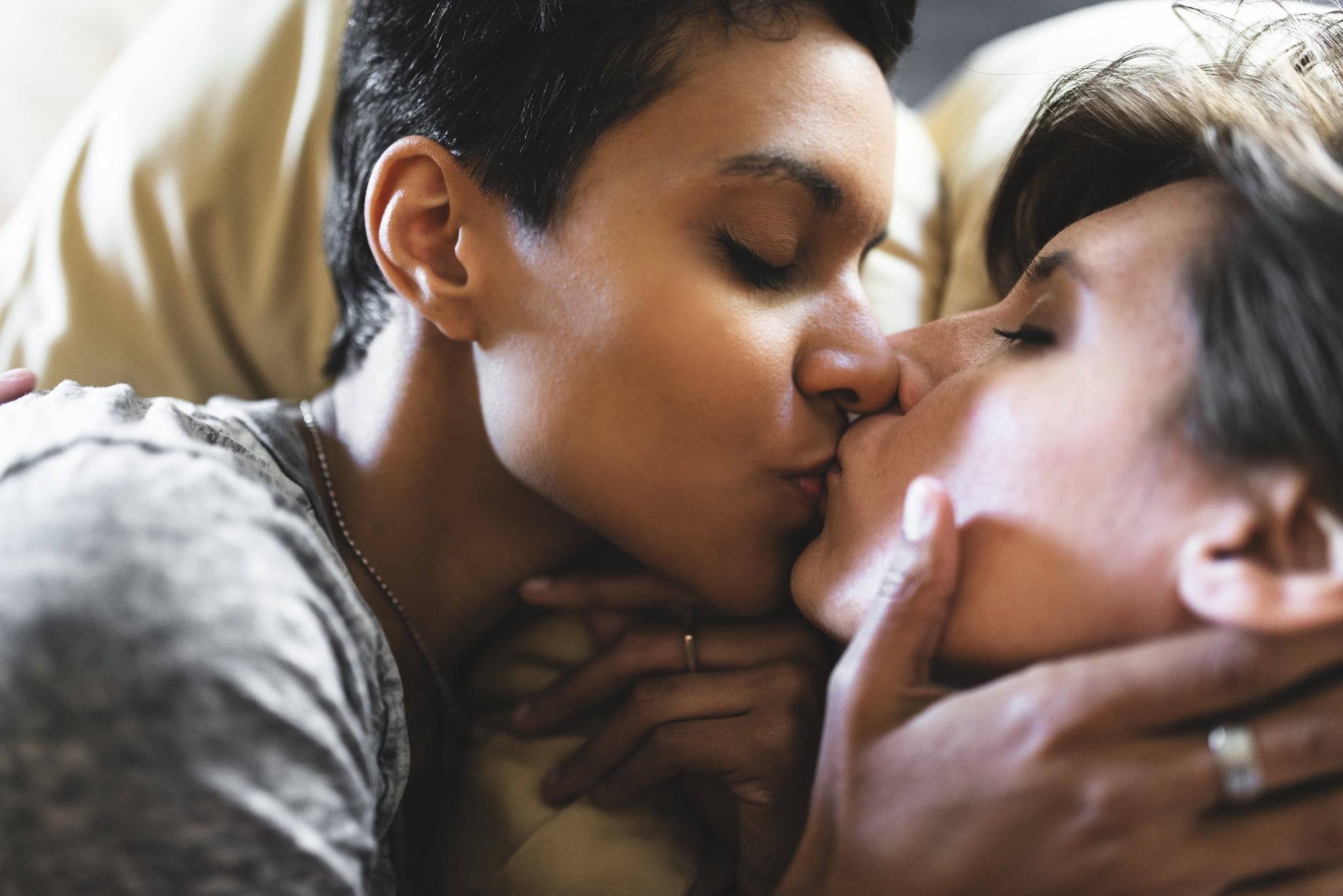 lesbian couple share the kiss on the bed