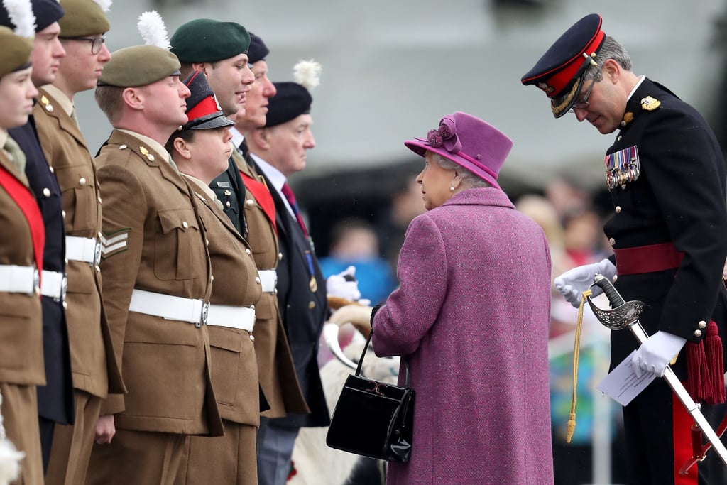 The Queen looks up to members of The Royal Welsh.