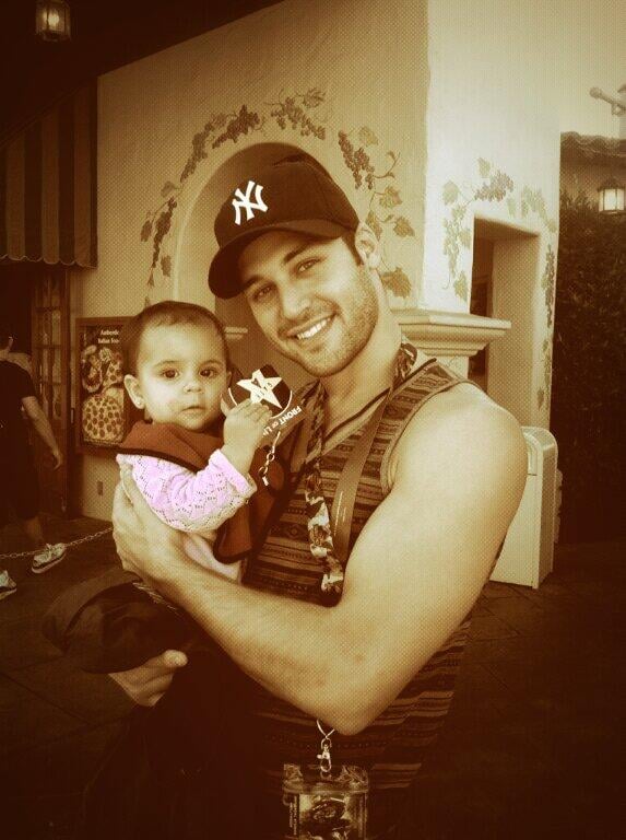Here he is sweetly putting those hot arms around his niece.