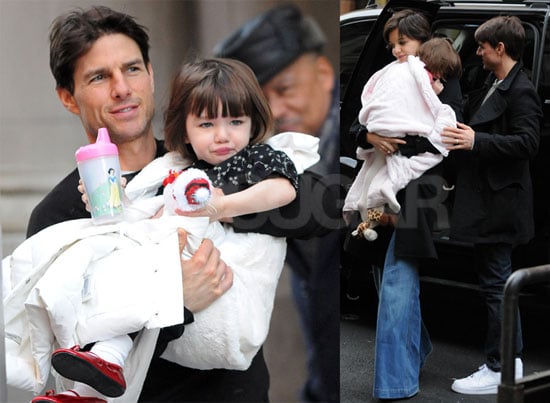Tom and Katie Carry a Bundled up Suri