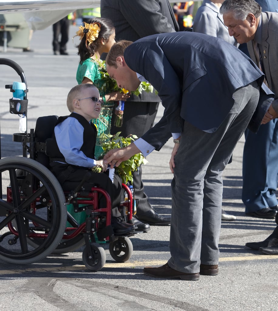 Will bent down to shake hands with a young boy in a wheelchair as the royal couple departed the Yellowknife airport in Canada back in July 2011.