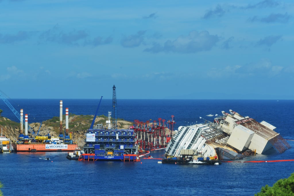 Barges surrounded the wreckage of the ship, which crashed into the rocks more than a year and a half ago.