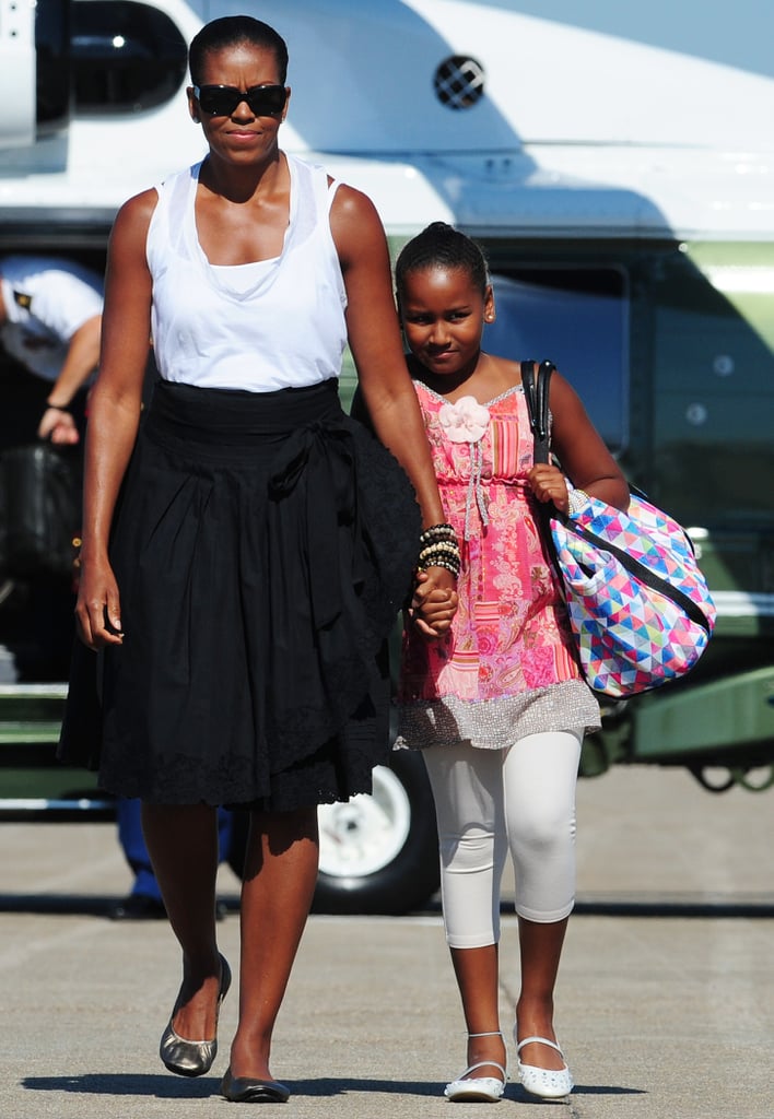 In August 2010, Sasha held on tight to her mother's hand as they headed out of Massachusetts on Air Force One.