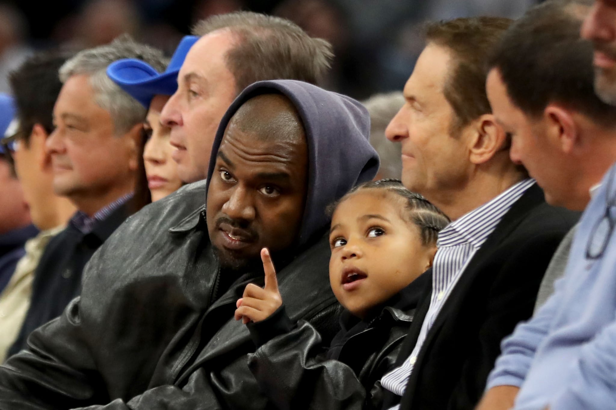 SAN FRANCISCO, CALIFORNIA -  MARCH 16: Kanye West, centre, and his son, Saint West, got front row seats next to Golden State Warriors co-owners Joe Lacob and Peter Guber as they watch the game against the Boston Celtics in the second quarter at Chase Centre in San Francisco, Calif., on Wednesday, March 16, 2022.  (Photo by Ray Chavez/MediaNews Group/The Mercury News via Getty Images)