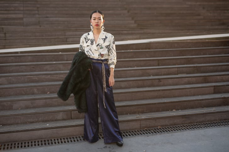 Navy trousers feel exciting with a printed blouse and statement | How ...