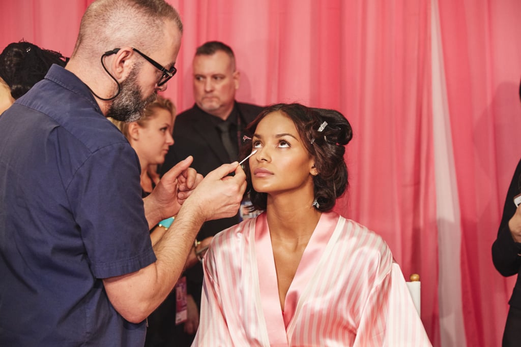 Dick Page blends under-eye makeup with a cotton swab.