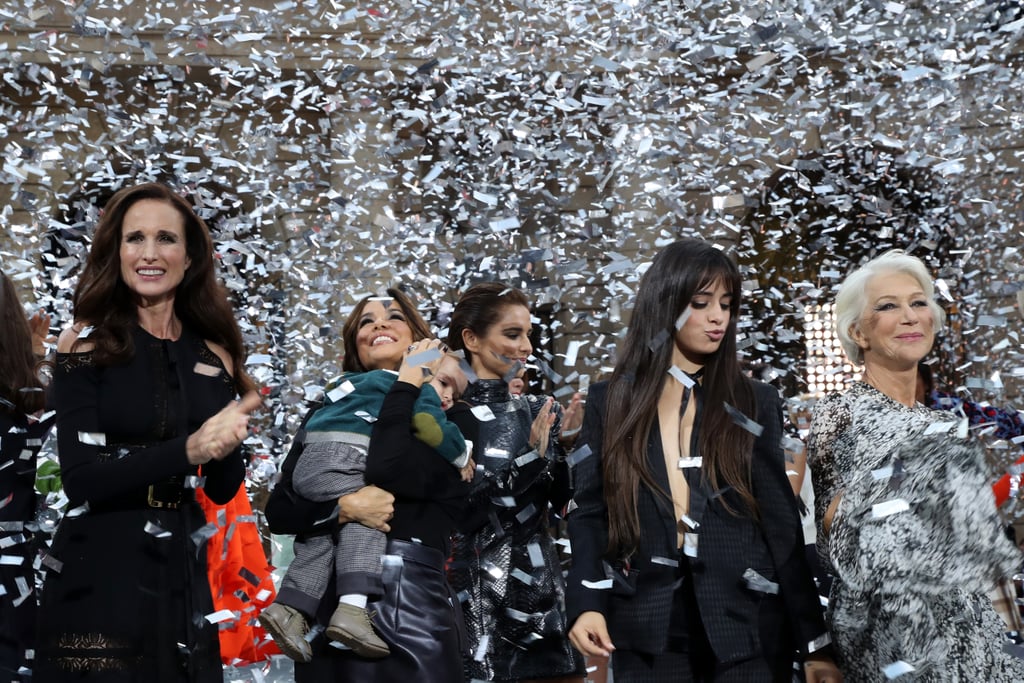 Camila posing with (from right to left) Andie McDowell, Eva Longoria and her son Santiago, Cheryl Cole, and Helen Mirren, under a shower of silver confetti during the finale of the Le Défilé L'Oréal Paris fashion show.