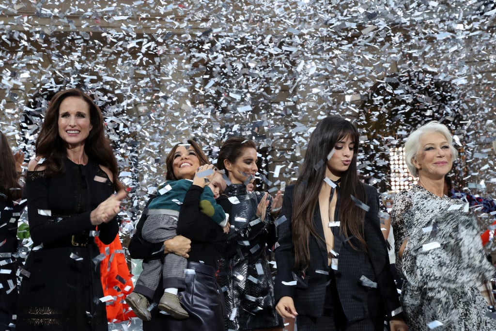 Camila posing with (from right to left) Andie McDowell, Eva Longoria and her son Santiago, Cheryl Cole, and Helen Mirren, under a shower of silver confetti during the finale of the Le Defile L'Oreal Paris fashion show.